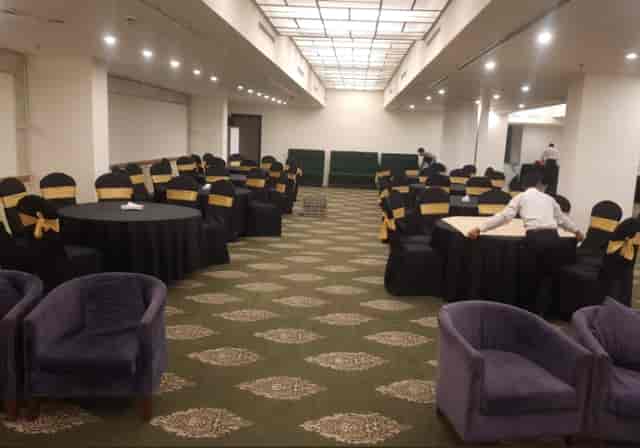 Platina Ballroom at Indigo Hotel, elegant setup for formal events with gold-accented tables.