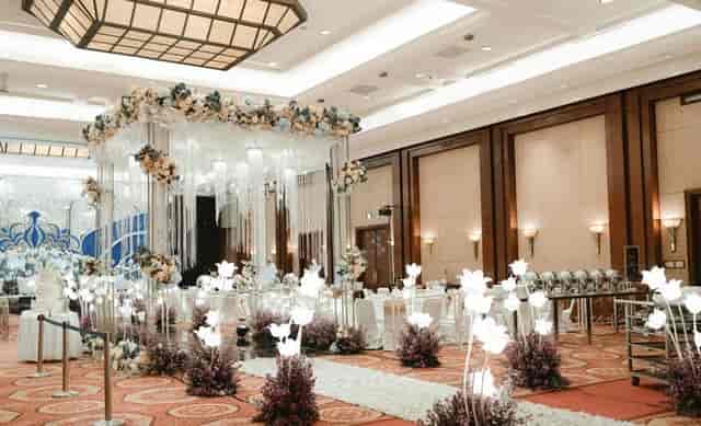 Elegant ballroom with floral centerpiece for weddings and corporate events at JW Marriott Jakarta.