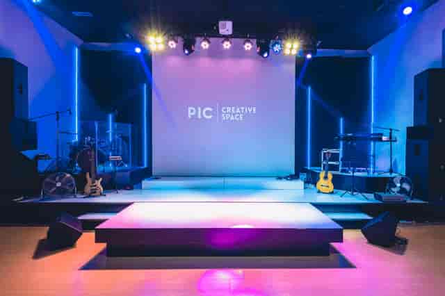 Versatile event space at Hotel Arwana with polished stage for corporate events.
