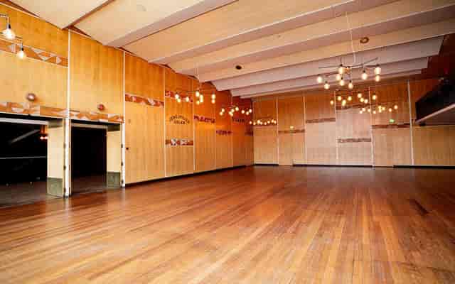 Spacious VEGA lounge with wooden floors, perfect for corporate events and weddings.