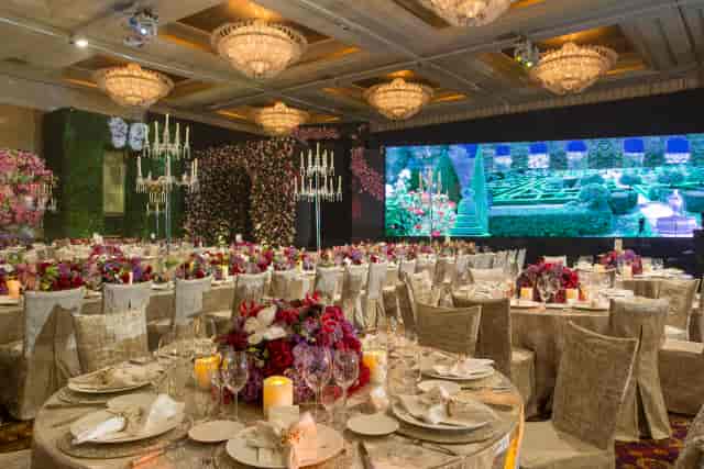 Grand Ballroom at Hotel Mulia Senayan, elegant venue for weddings and galas, floral centerpieces.
