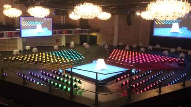 Exhibition Area at Tivoli Hotel, vibrant stage and chairs for corporate events.