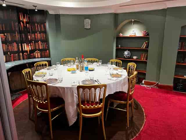 Elegant round table in cozy private dining room at Jananeh Restaurant for upscale events.