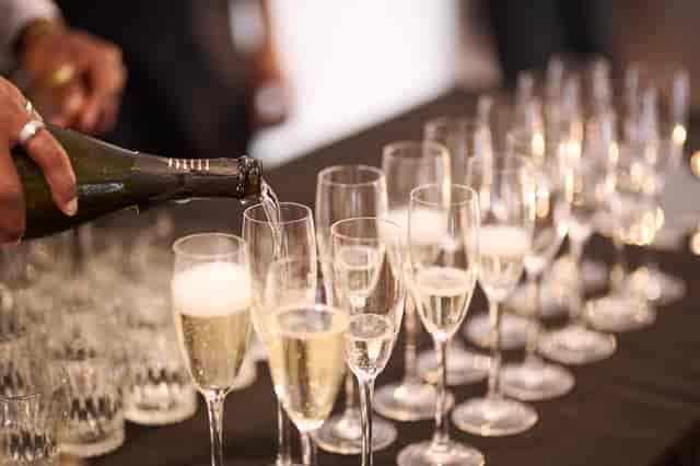 Elegant champagne pouring in OXO2's West Wing for a sophisticated celebration event.