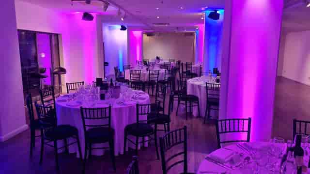 Elegant event space in OXO2 with round tables, perfect for corporate gatherings.