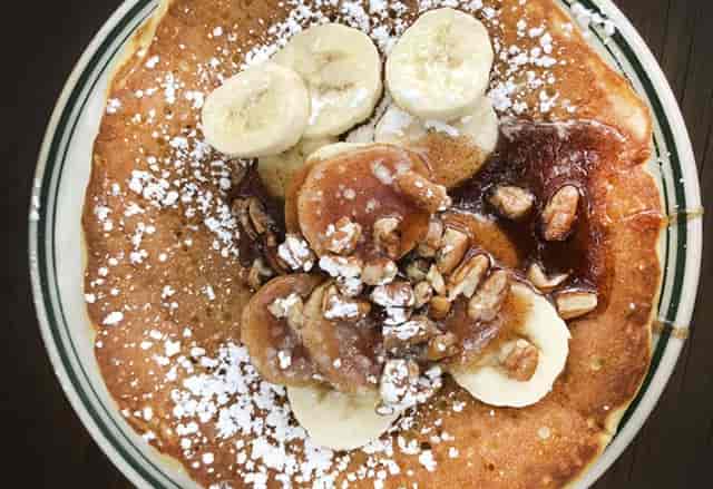 Pancake dish with banana and nuts in Northwoods Private Room, perfect for brunch events.