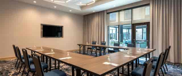 Conference room with U-shaped seating at Hilton Garden Inn Boston Canton for corporate events.