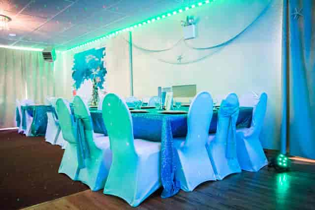 Elegant banquet hall with blue tablecloths ready for special events and celebrations.