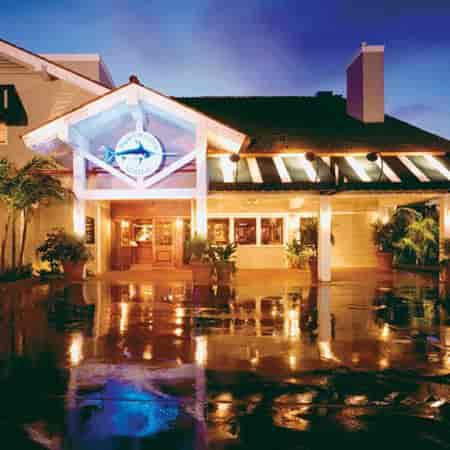 Upscale bar at Bluewater Grill with tropical decor, ideal for evening events and receptions.