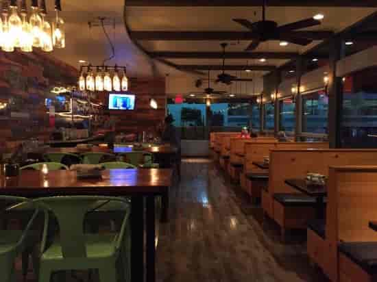 Modern dining space at R10 SOCIAL HOUSE with warm lighting, ideal for networking events.