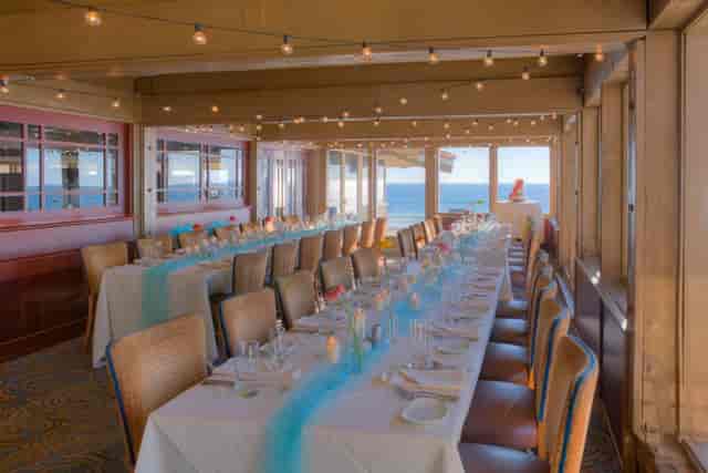Elegant dining room with ocean view, perfect for weddings and corporate events.