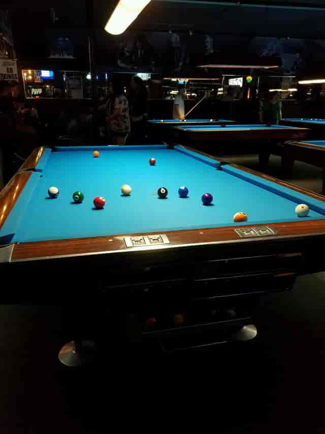 Billiards table with colorful balls at Mr. Lucky's for networking and social events.