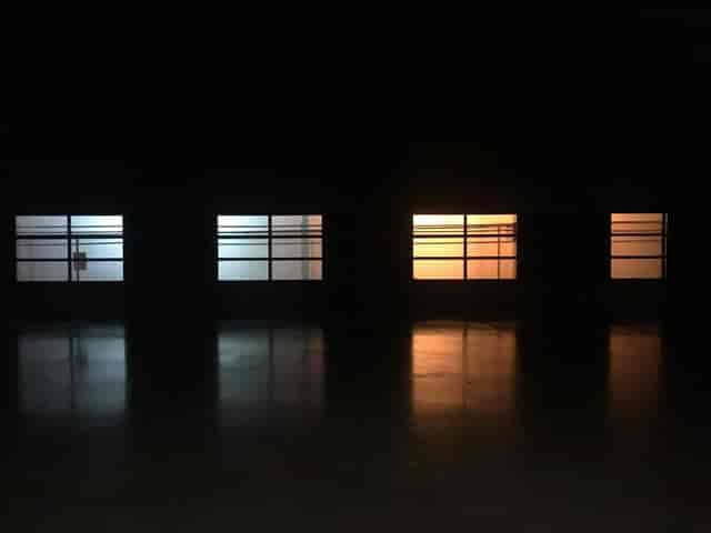 Versatile event venue with tinted blue and orange windows, ideal for networking and art events.