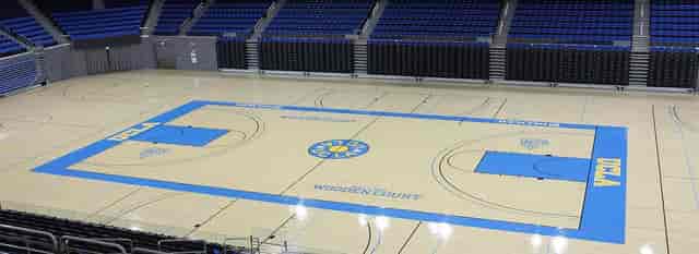 Pauley Pavilion basketball court for events, featuring vibrant markings and spectator seating.
