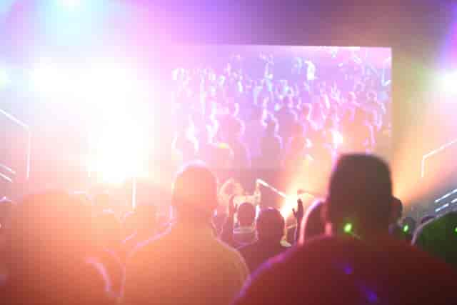 Vibrant EPIC LIVE LOUNGE event with dynamic lighting and engaging video screen.