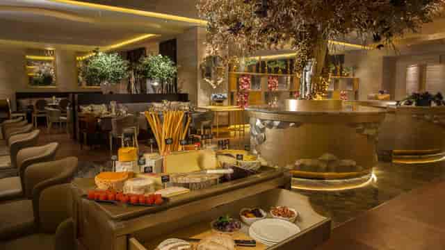 Elegant dining at il Mare, Hotel Mulia with inviting ambiance and gourmet food display.