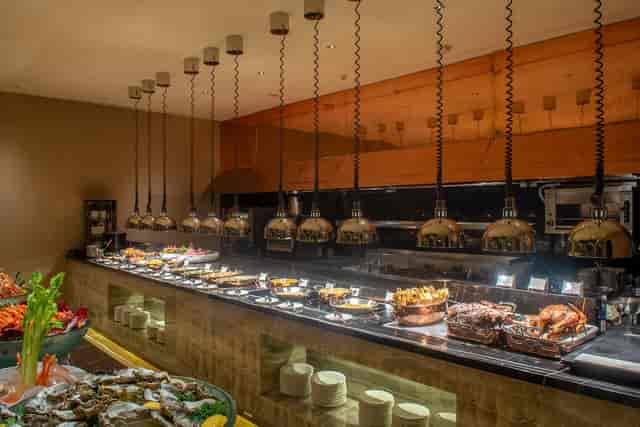 "Elegant food display at il Mare, Hotel Mulia event, featuring stylish pendant lighting."