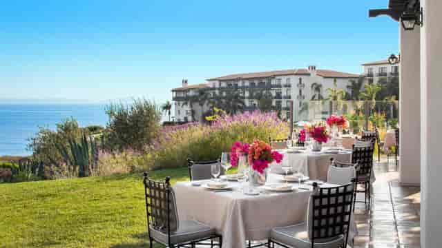Outdoor event setup at Terranea Resort with vibrant floral centerpieces and ocean view.