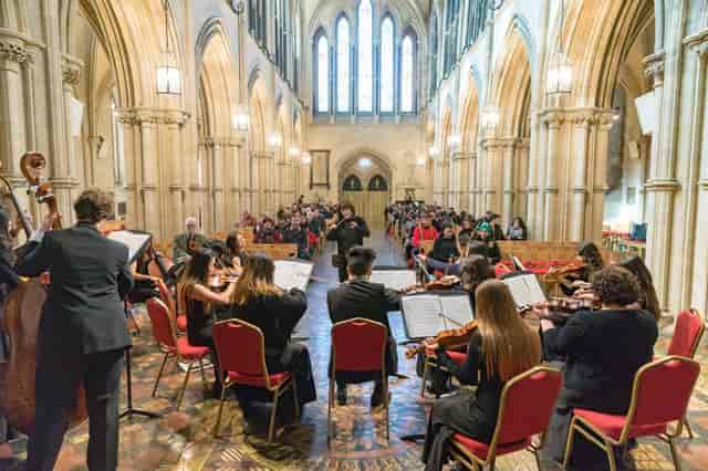 Live orchestral performance in La Cañada High School's elegant auditorium foyer, ideal for events.