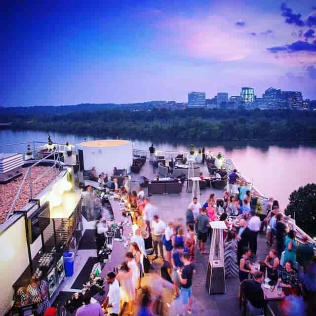 Rooftop event at Top Of The Gate, Watergate Hotel, with stunning sunset skyline.