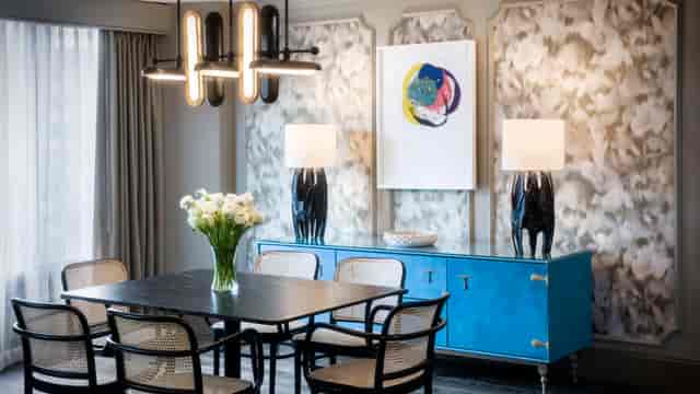 "Stylish meeting space with modern table, chic chairs, and vibrant decor for corporate events."
