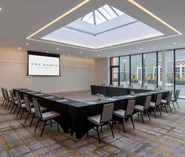 Modern meeting room at The Darcy with long table setup for corporate retreats and workshops.