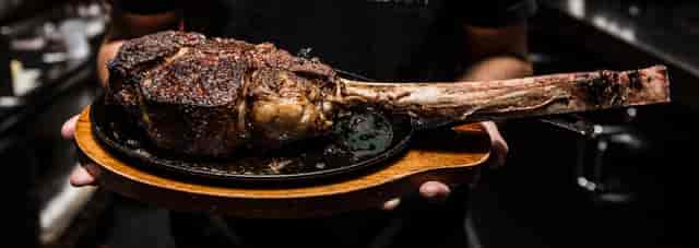 Tomahawk steak showcase for upscale events and interactive dining experiences.