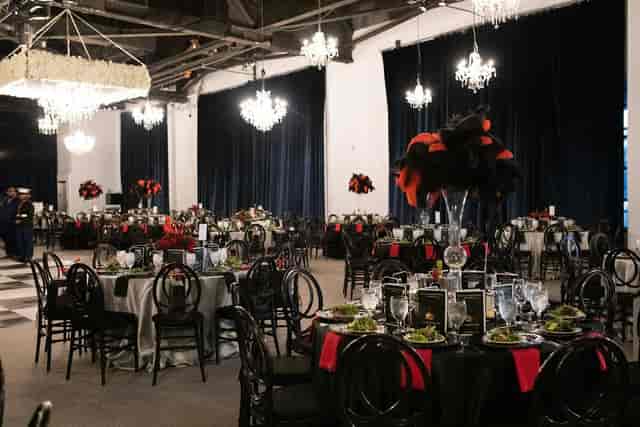 Elegant gala event space with dark linens and bold centerpieces at Bayou Place.