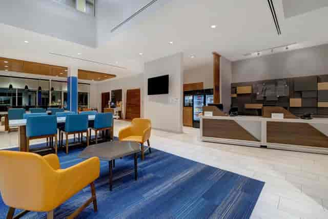 "Modern breakfast bar with blue and yellow seating at Holiday Inn Express Glendale for networking."