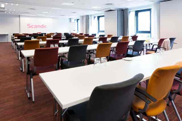 Conference center meeting room with natural light, ideal for corporate events and workshops.