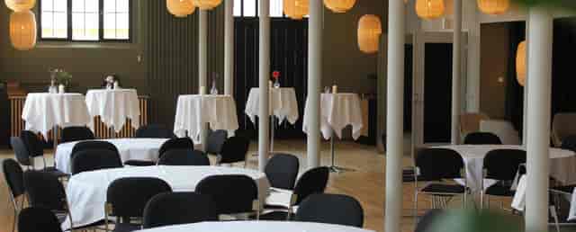 Elegant Spisehuset venue with high-top tables for networking events and receptions.