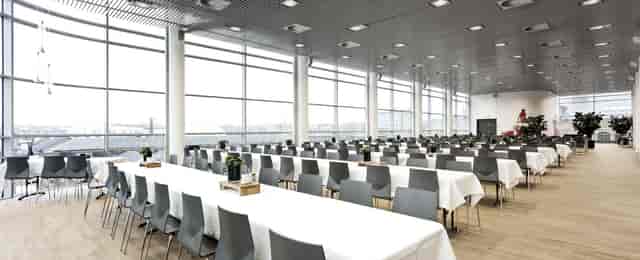 Spisehuset banquet space with elegant tables, ideal for conferences and events.
