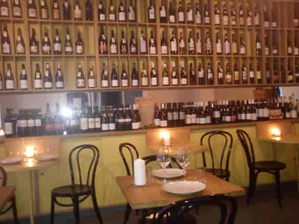 Cozy wine bar with candlelit tables, ideal for intimate gatherings and networking.