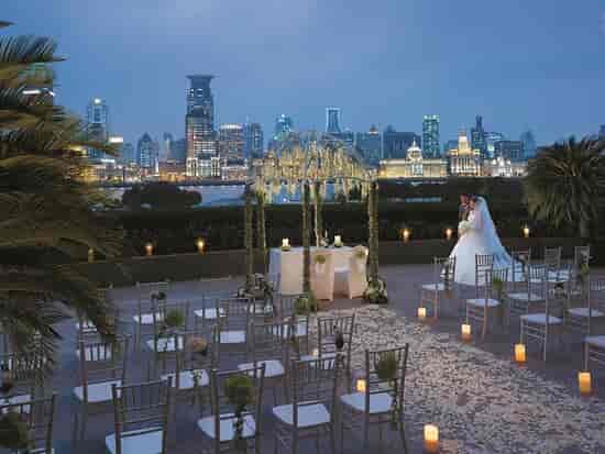 Elegant outdoor wedding venue at Pudong Shangri-La, Shanghai, with city skyline backdrop.