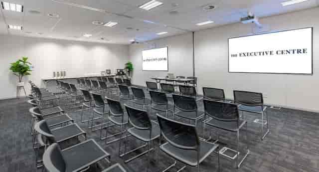 Modern event space with dual screens for corporate meetings and seminars.