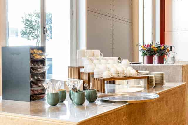 Salon De La Vaulx refreshment station with coffee and pastries for networking events.