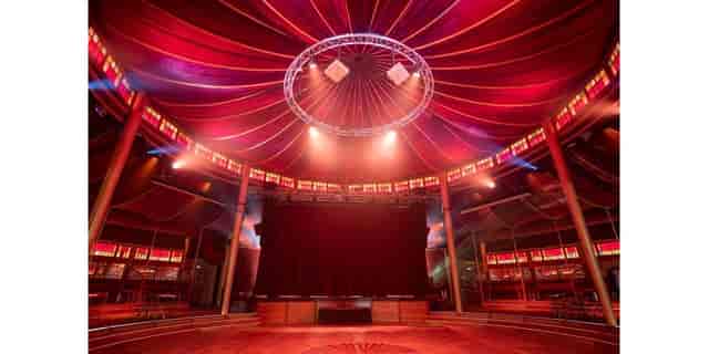 Espace Chapiteaux with red canopy, perfect for events and performances.