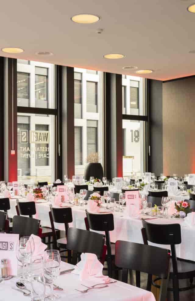 Sophisticated cafe event space with elegant tables, perfect for formal gatherings and corporate events.