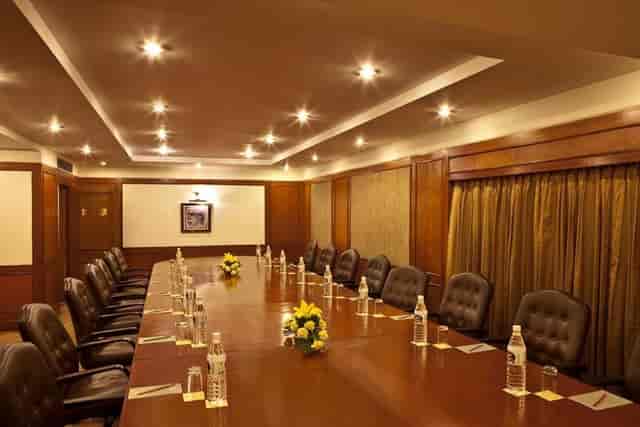 Boardroom at Hotel Hill Stone Residency, polished table and leather chairs for executive meetings.