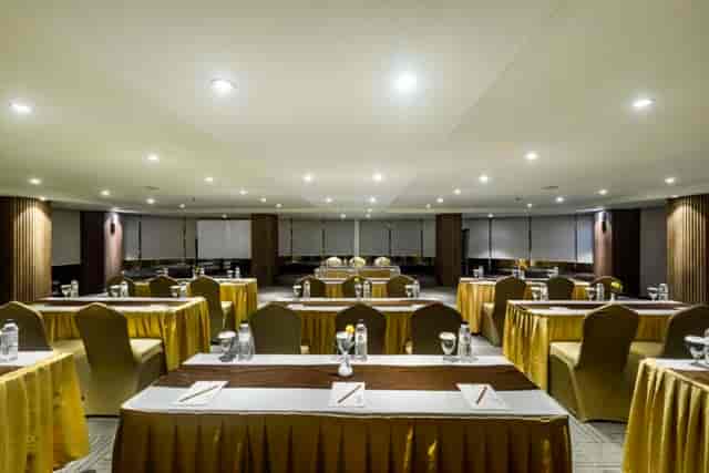 Meeting room at The Nest Hotel with gold tablecloths, ideal for conferences and workshops.