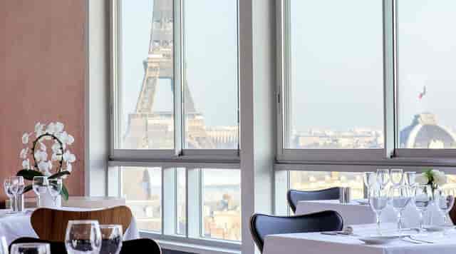 Elegant dining area at UNESCO Restaurant with Eiffel Tower view for corporate events.