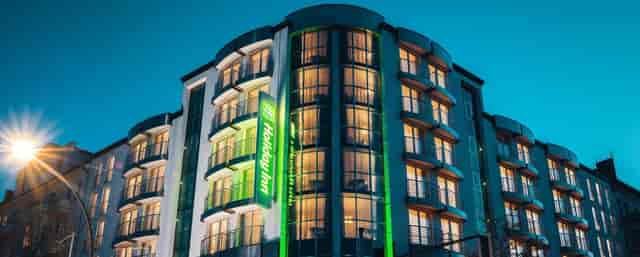 Modern Holiday Inn Berlin, sleek exterior for corporate meetings and social events.