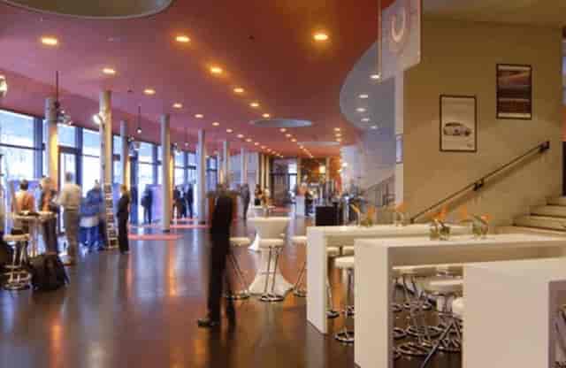 Modern Tempodrom foyer with sleek furniture for networking and events.