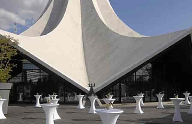 Modern Tempodrom foyer with high-top tables for elegant networking events.