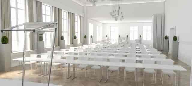 Modern conference room with white furniture, ideal for corporate meetings and seminars.