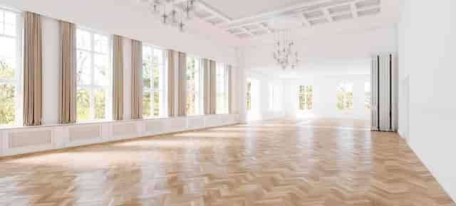 Spacious Villa Schützenhof hall with elegant chandeliers for corporate events and gatherings.