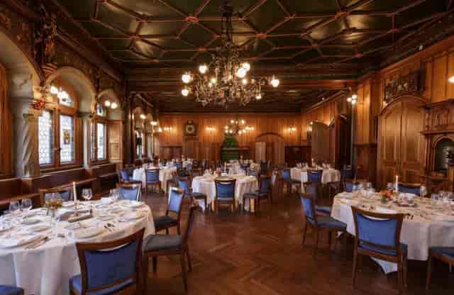 Elegant banquet hall with white tables, ideal for weddings and corporate events.
