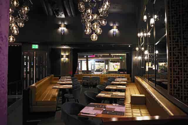 Modern restaurant with elegant furnishings, perfect for corporate dinners and networking events.