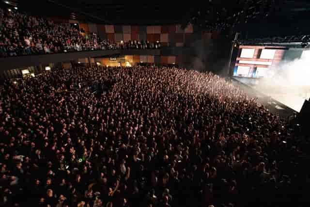 Packed venue in GALLERY with elevated audience and smoke effects for dynamic events.