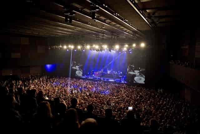 Packed concert venue showcasing vibrant lighting and excellent acoustics for live events.